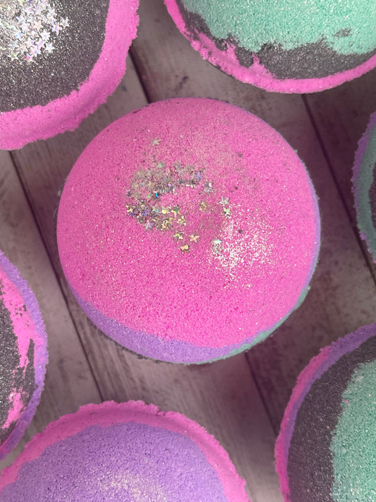 The Galaxy Bath Bomb is black, pink, teal, and purple.  It has star glitter and other biodegradable glitter in it.